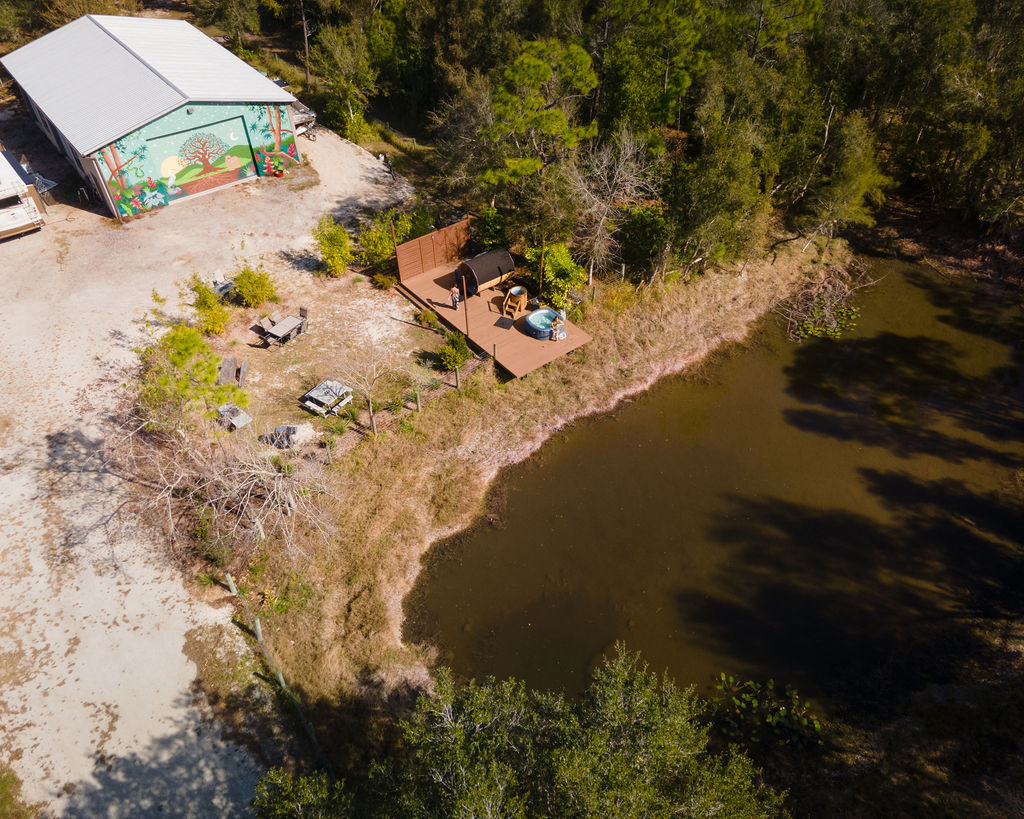 Aerial of the lake, sauna deck, and barn at Serenity Star