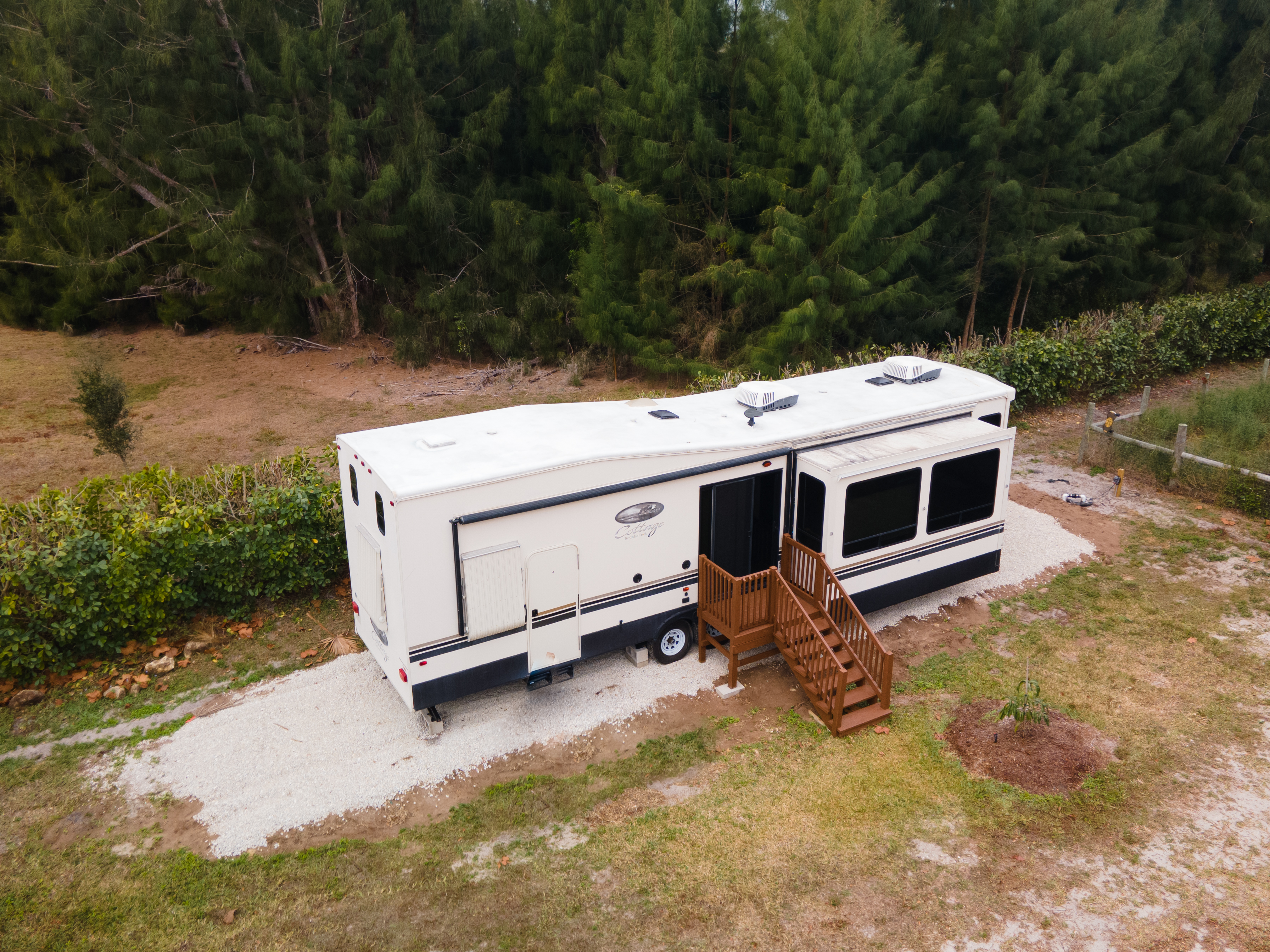 Exterior of the camper accommodation at Serenity Star, surrounded by Florida pine forest